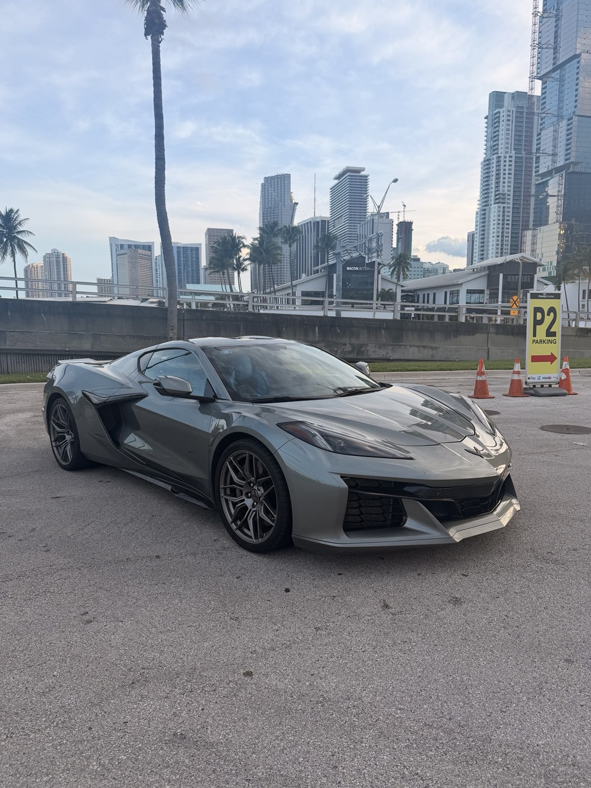 Gray Corvette Z06 front three-quarter view with Miami skyline